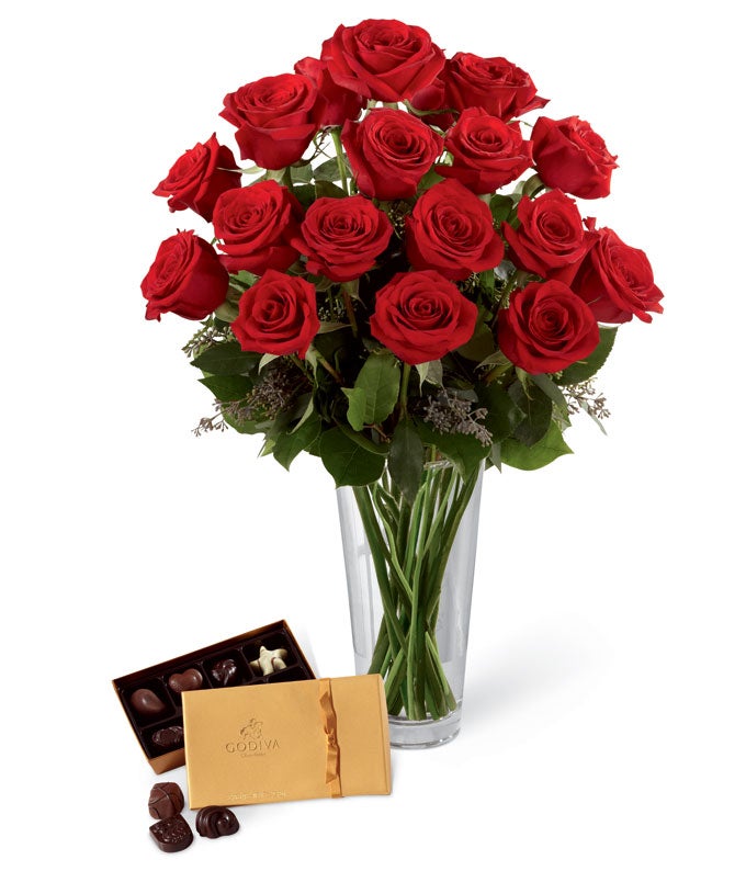 A Bouquet of Long-Stem Red Roses, Seeded Eucalyptus, and Lush Greens in a Clear Glass Vase with 8-piece Box of Godiva Chocolates