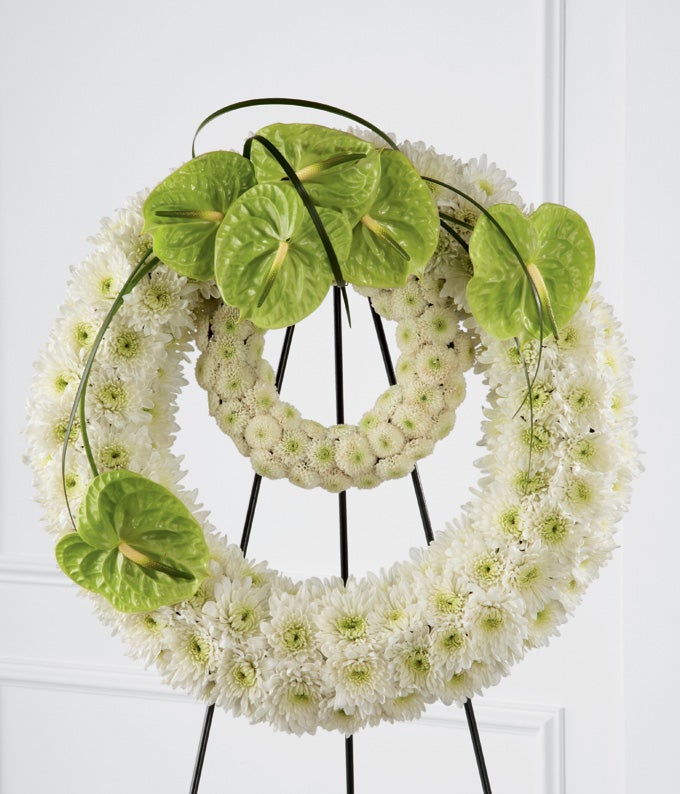 Round  Flower arrangement including  White Chrysanthemums, White Button Poms, 2 pieces Ring Centerpiece, and Green Anthurium with Stand Included