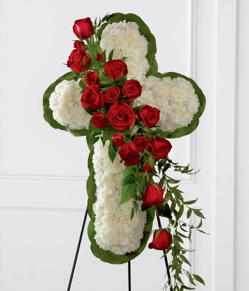 Cross shaped standing spray with red roses and white carnations