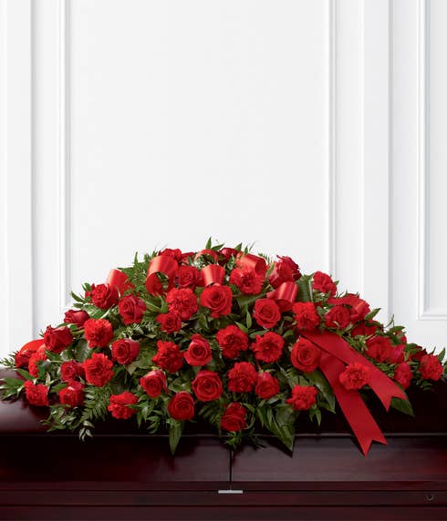 Red roses and red carnations in a casket spray