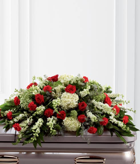 Red rose casket spray with white hydrangea, red carnations and red roses