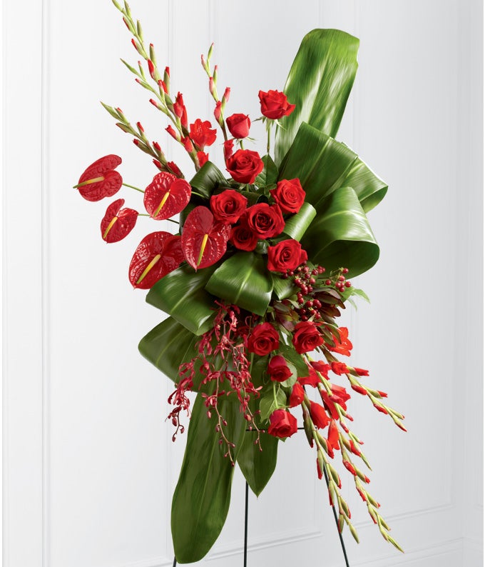 Red Anthurium, Cardinal Hued Gladiolus, Scarlet Roses, James Storei Orchids, and Hypericum Berries with   Stand Included