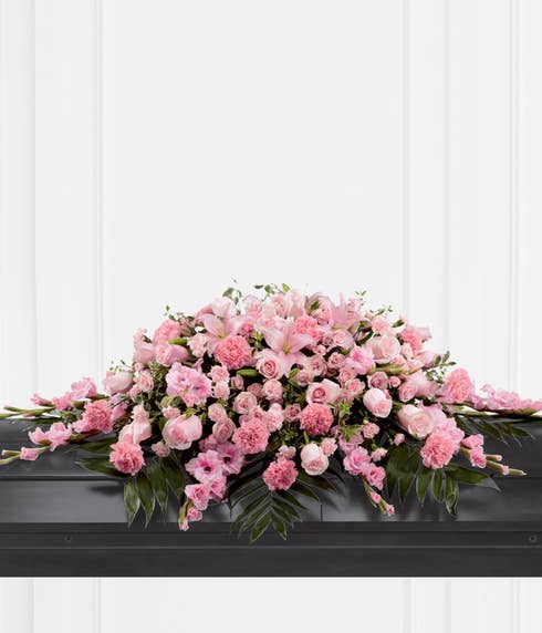 Pink Floral casket spray with roses, carnations and lilies