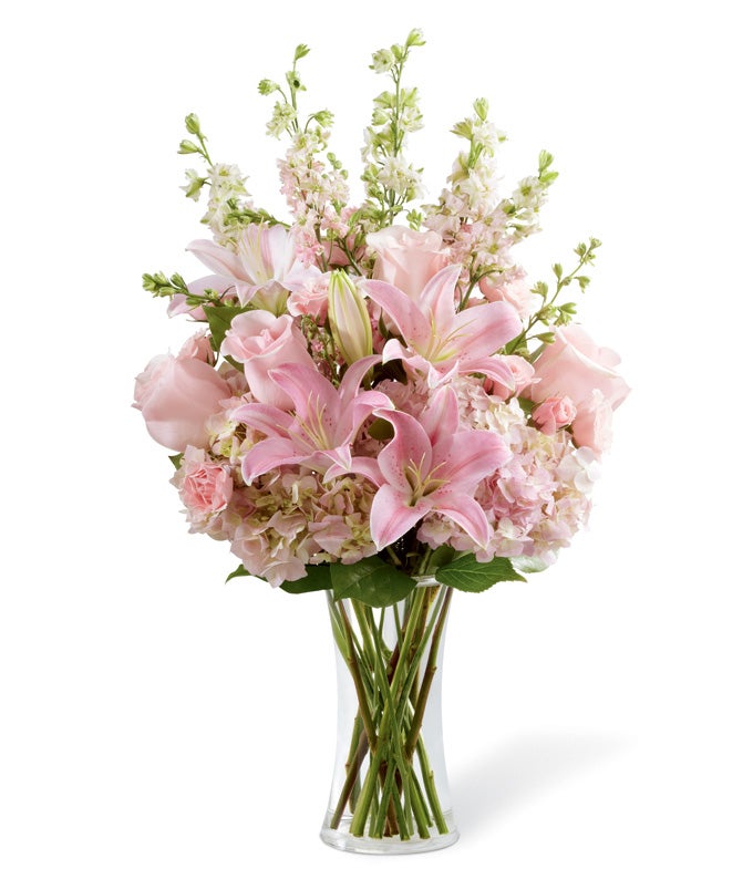 A Bouquet of Light Pink Roses, Pink Spray Roses, Oriental lilies and Pink Hydrangea in a Clear Gathering Vase
