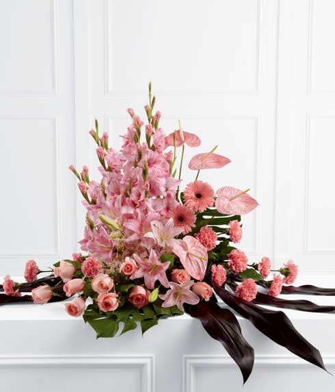 Pink gladiolus and rose sympathy flower arrangement with oriental lilies and daisies