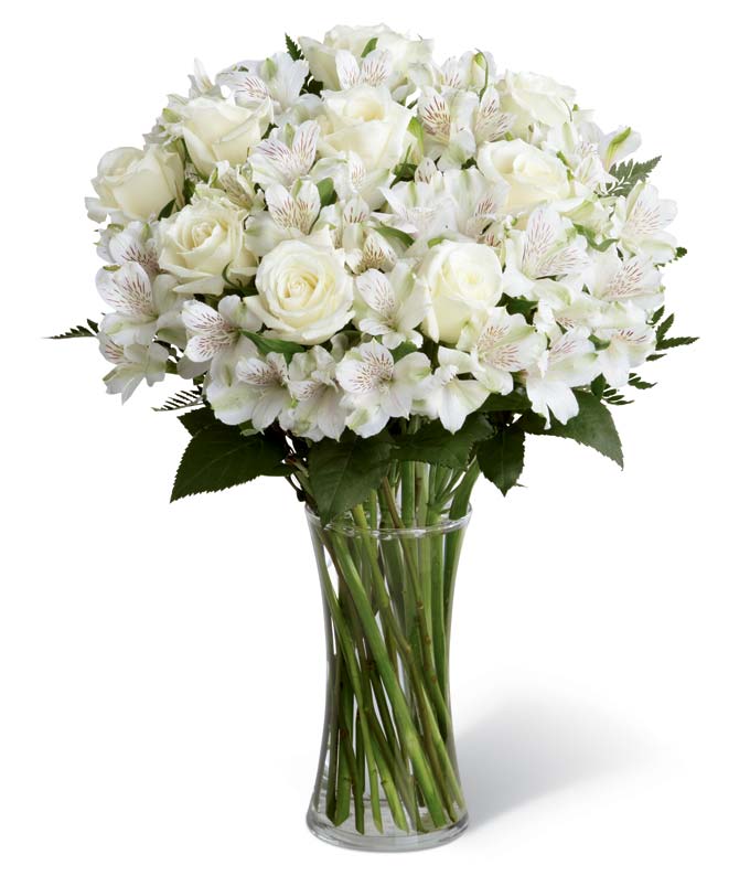 Sympathy bouquet with white roses and peruvian lilies in gathering vase