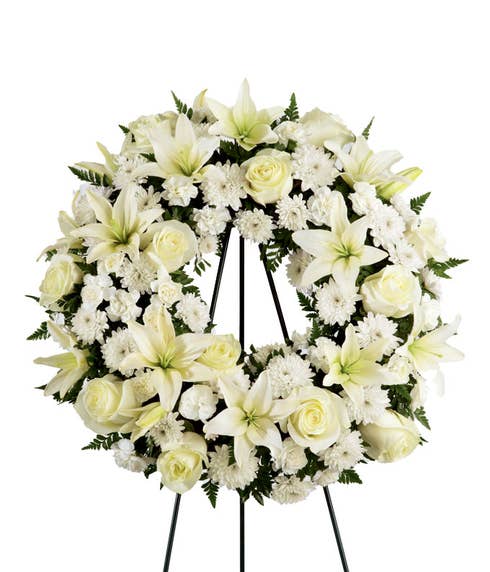 Open center funeral flowers wreath ring standing spray of white roses and lilies