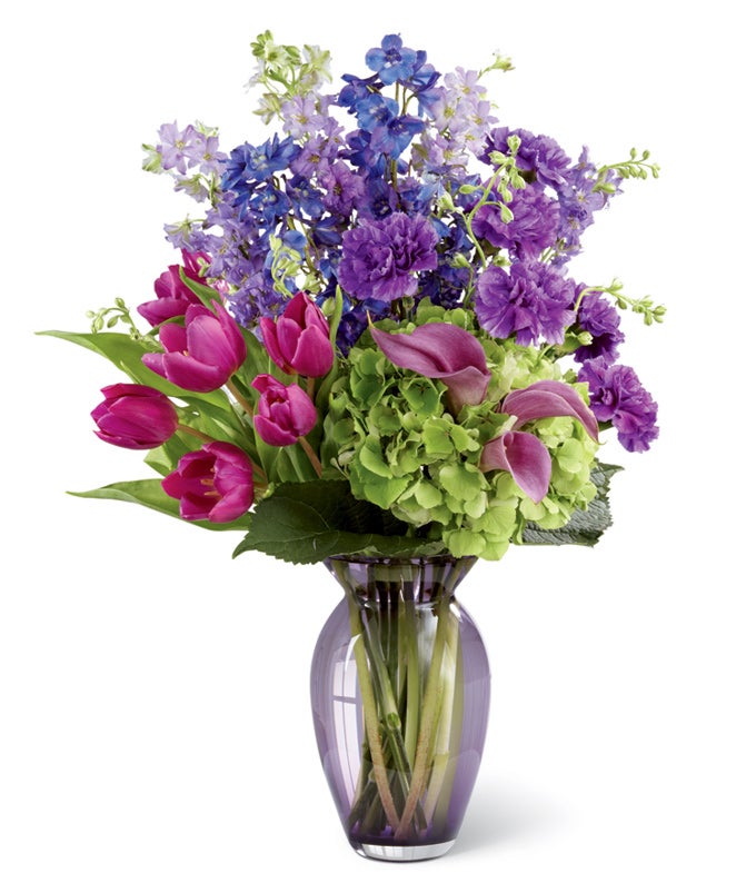 A Bouquet of Purple Tulips, Blue Delphinium, Purple Mini Calla Lilies and Purple Carnations in a Glass Vase