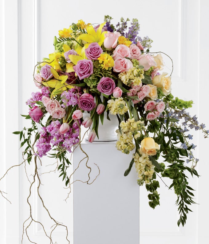 A Bouquet of Lavender, Pink, & Yellow Roses, Pink Tulips, Lavender Larkspur, Bells of Ireland, Yellow Freesia, Yellow Lilies, Blue Delphinium and Green Hydrangea