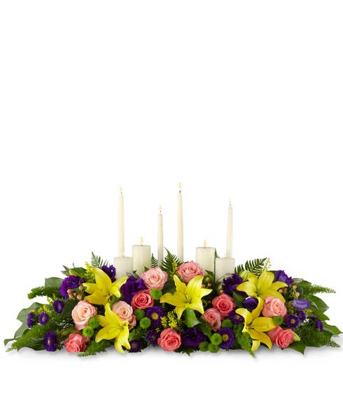 Yellow lily, peach rose and white candles centerpiece with 8 candles