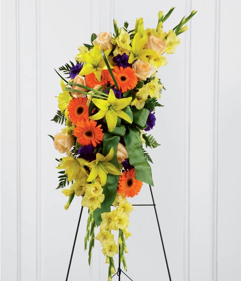 Oval funeral flowers standing spray delivery with tropical flowers and easel