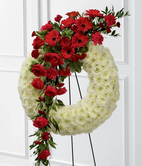 White carnations round open center ring wreath funeral flower standing spray