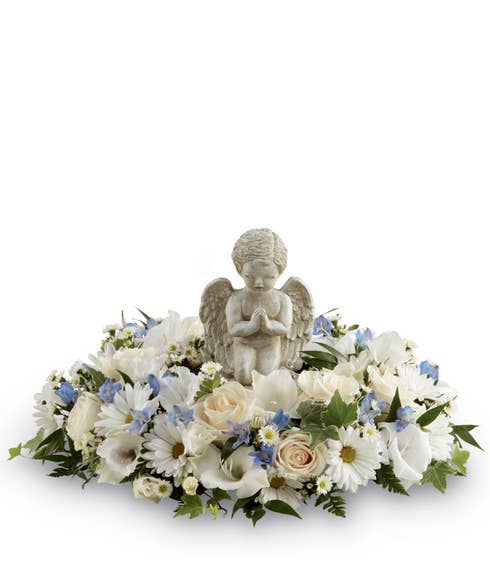 white flower angel funeral flowers, figurine flower arrangement with angel figure
