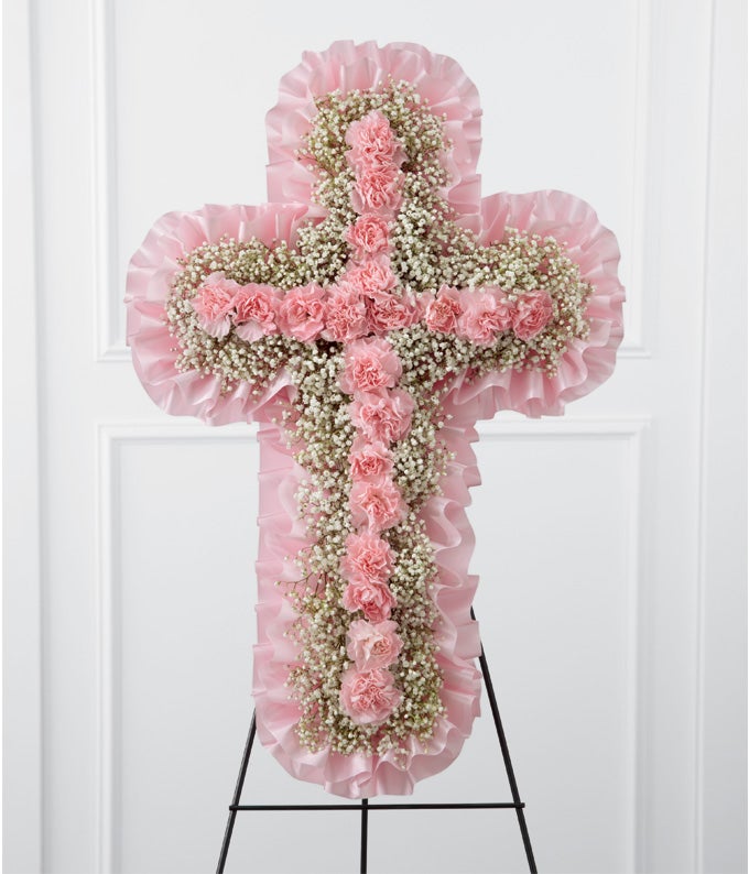 Cross shaped standing spray including Pink Mini Carnations and Baby's Breath with Satin Bow Trim