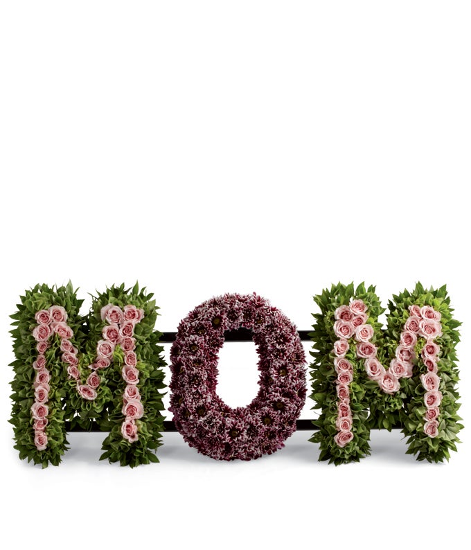 The word MOM Flower arrangement including Light Pink Spray Roses, Bells of Ireland and Daisy Poms