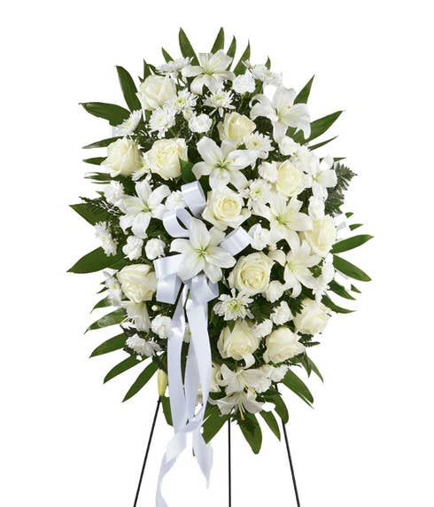 Sympathy spray for delivery with white roses, lilies and carnations