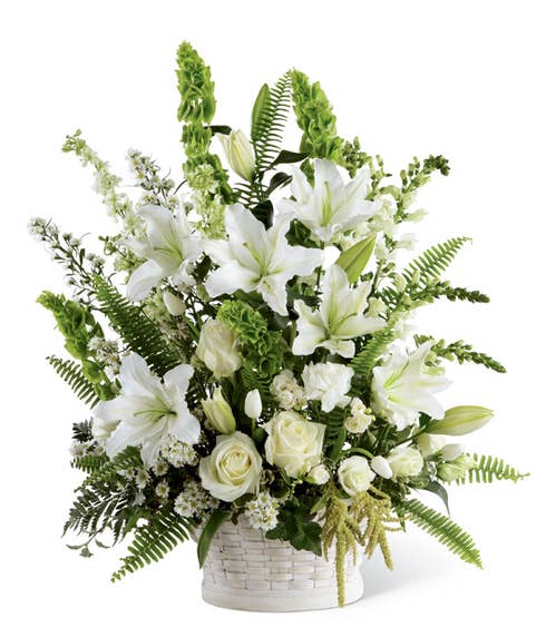 White sympathy flower arrangement with oriental lilies, white tulips and asters