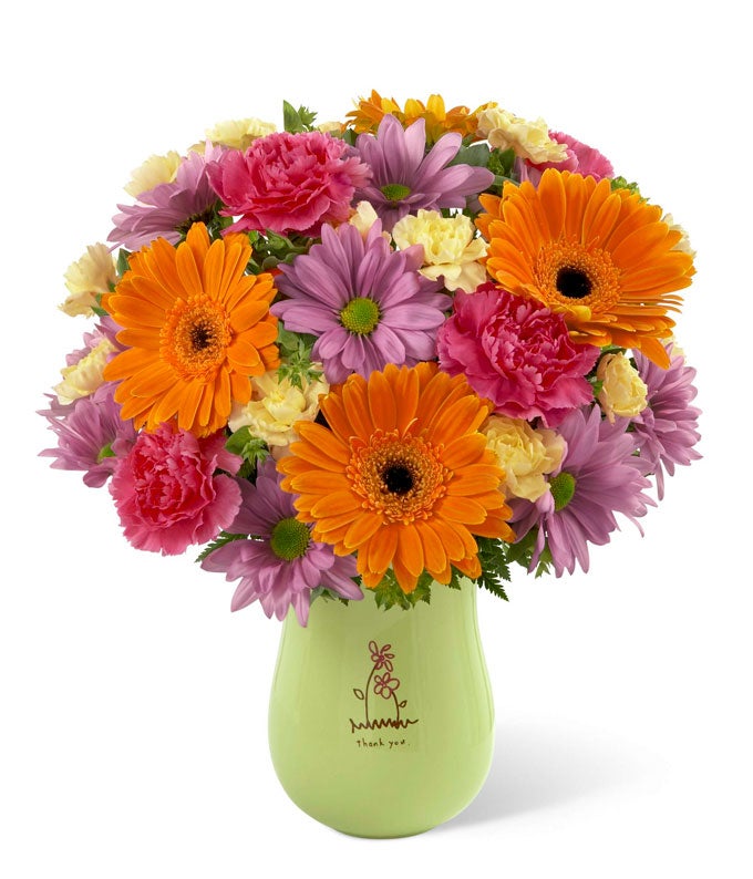 A Bouquet of Orange Gerbera Daisies, Fuchsia Carnations, Lavender Traditional Daisies and Yellow Mini Carnations in a Thank You Themed Vase