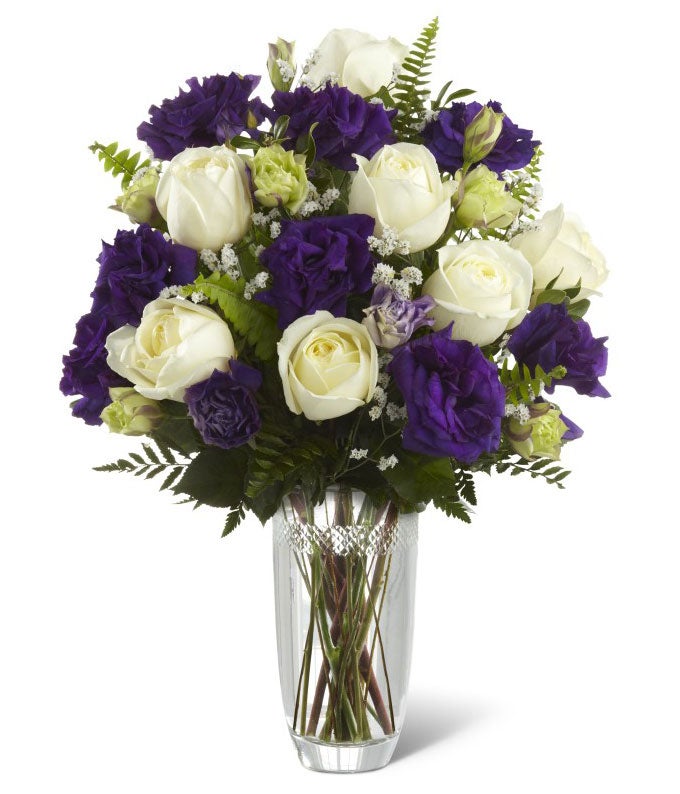 White roses and purple flowers in decorative vase