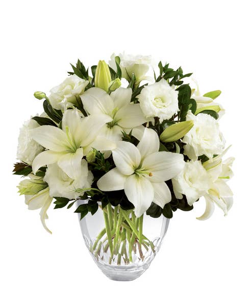 White asiatic lilies, lisianthus and white flowers in a floral delivery