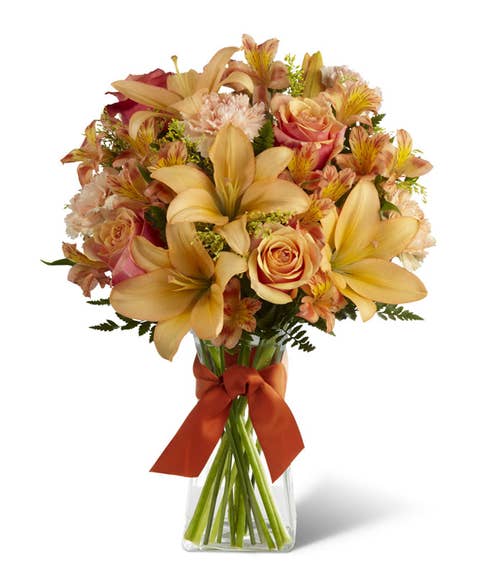 Orange roses, peach asiatic lilies and orange carnations bouquet