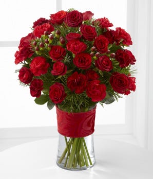 Red spray roses and red carnations in popular Christmas bouquet 