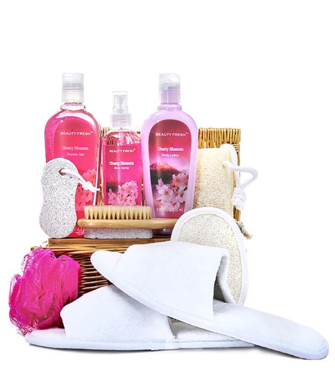 Body Lotion And Spray, Shower Gel, Bath Scrub, Exfoliation Brush, Slip On Slippers and Soft Loofah in a basket