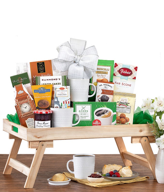 Basket that includes coffee and tea and pastries and cookies and jelly and waffle mix and a coffee mug
