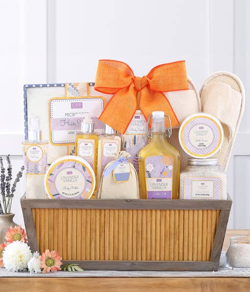 Mother's Day spa gift basket with an array of lavender vanilla scented Cru De Provence products, slippers, and bath accessories in a Relax gift container, including a personalized message card.