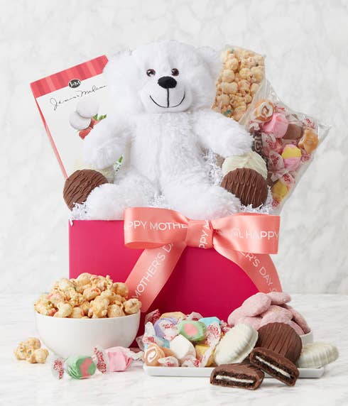Mother's Day pink gift box filled with white and milk chocolate dipped Oreos, confetti cake popcorn, raspberry cookies, taffy, and a white stuffed bear, including a personalized card message.