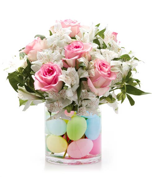 Pink roses with white alstroemeria in a vase with Easter eggs