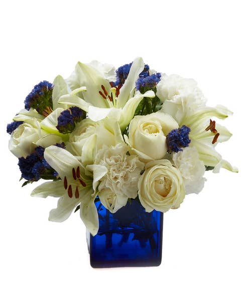 white rose and lily bouquet with flowers for men inside a blue vase