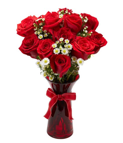 Farm fresh red roses with petite white flowers delivered in a red glass vase