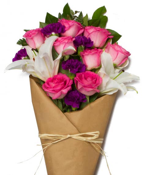Mixed wrap rose bouquet delivery with pink roses, purple carnations in vase