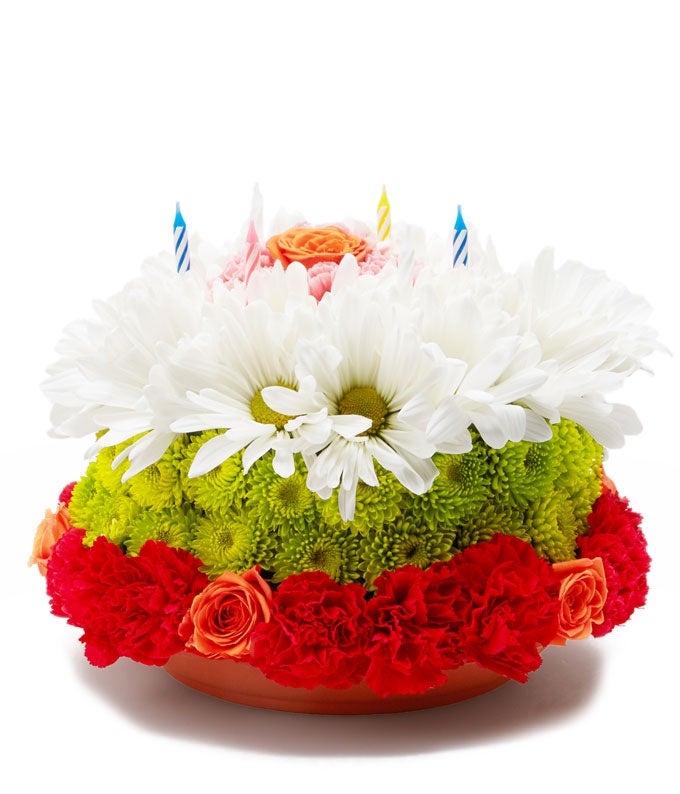 A Bouquet of Floral Cake-Shaped Arrangement Including Orange Spray Roses, Pink Carnations, White Daisies and Green Pompons