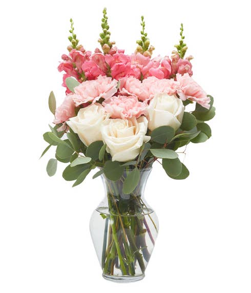 Pale pink and coral snapdragon flower bouquet with pink roses and vase