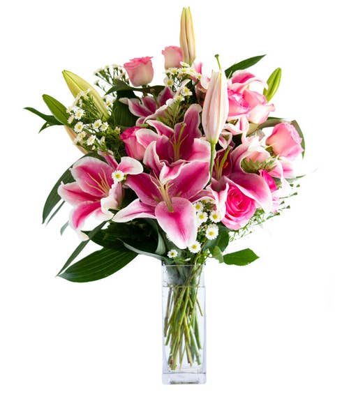 Pink rose and stargazer lilies in glass vase