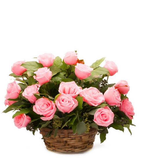 Pink roses basket bouquet in a woven basket with a card message