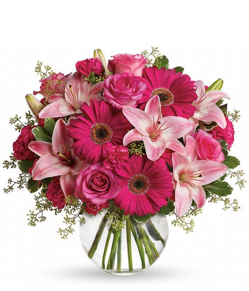 Adorable neon pink flower bouquet in round glass vase
