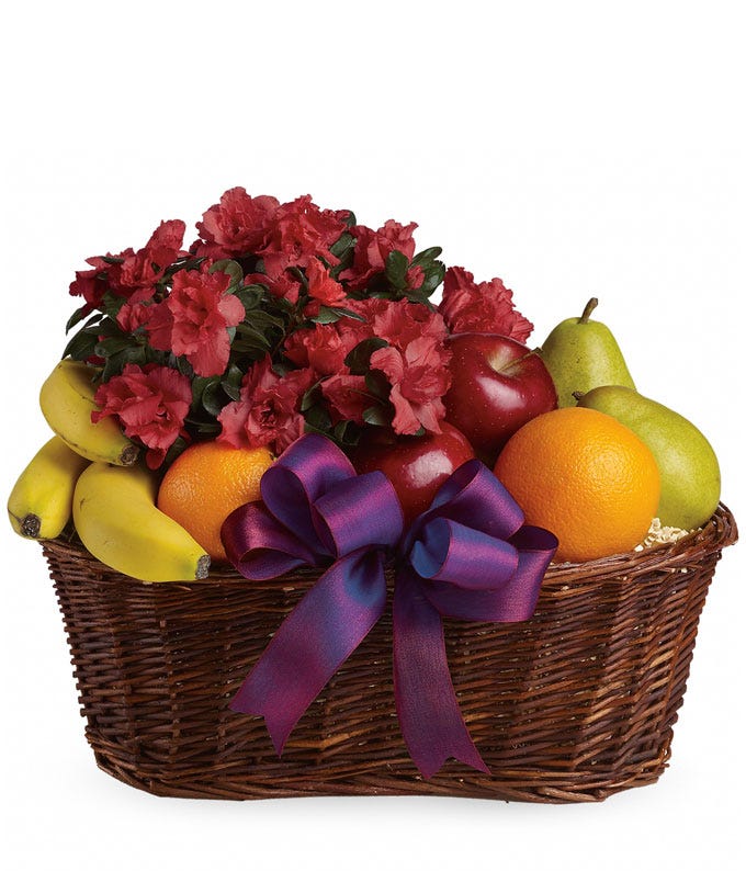 A Bouquet of Pink Azalea Plant with Apples, Oranges, Pears and Bananas in a Woven Basket