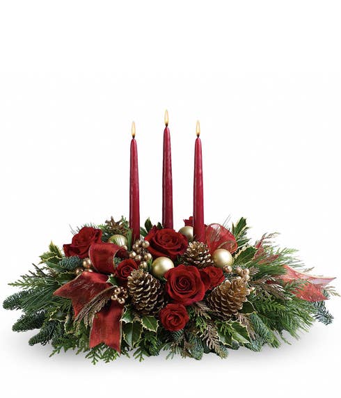 Red candle flower centerpiece with red roses, pinecones and christmas flowers