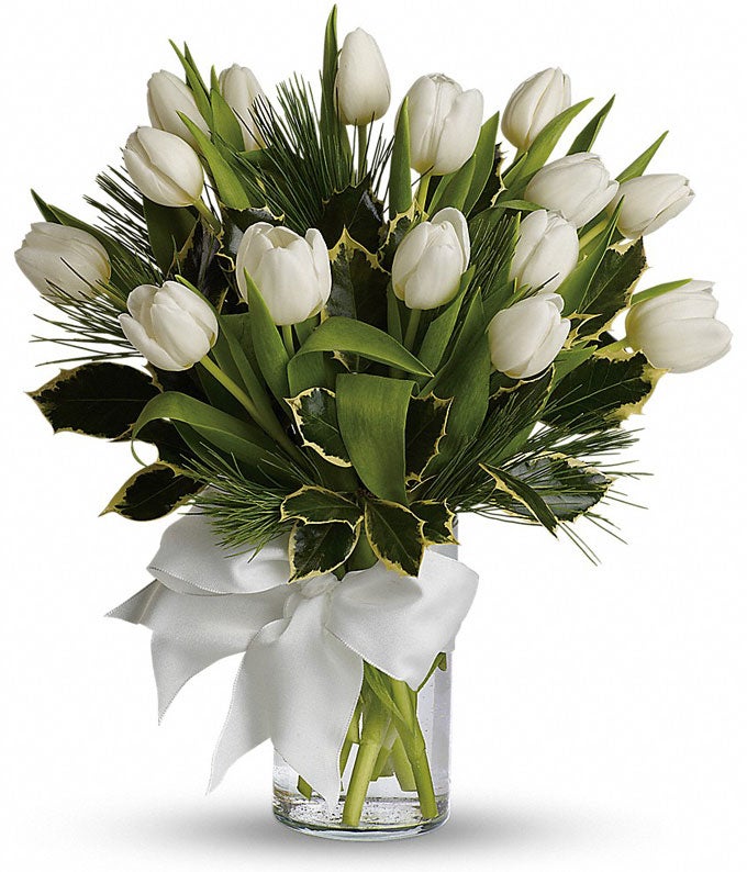 A Bouquet of  Ivory Tulips Bunch, Greens, Pine and Holly in a Glass Vase with Cream Bow