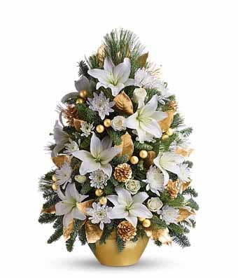 White lilies in a tiny christmas tree flower arrangement from send flowers