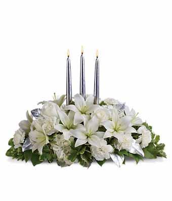 White lily centerpiece with white lilies, white hydrangea and carnations and candles