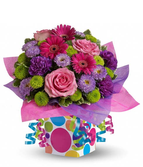 Multicolored confetti bouquet with multicolored flowers and party ribbon