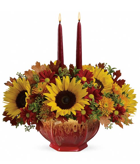 Sunflower, orange roses, and candle flowers centerpiece with octagon vase