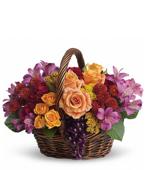 Summer flowers country basket with artificial grapes and woven handle basket