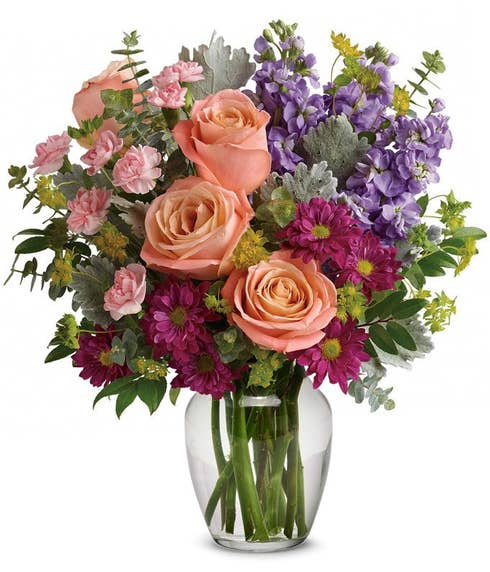 Mixed bouquet of flowers in a vase with pale pink roses, a vintage flower bouquet