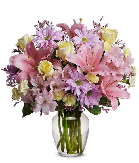 Mixed pastel flowers bouquet with pink lilies, yellow roses and lavender daisies