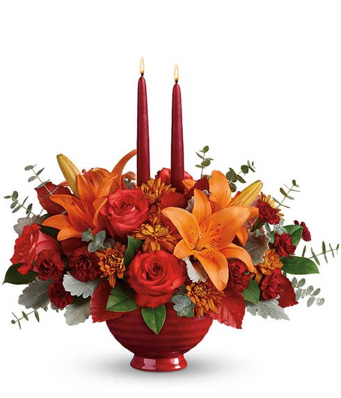 Fall flower candle centerpiece with dark orange rose, orange tiger lily and candles